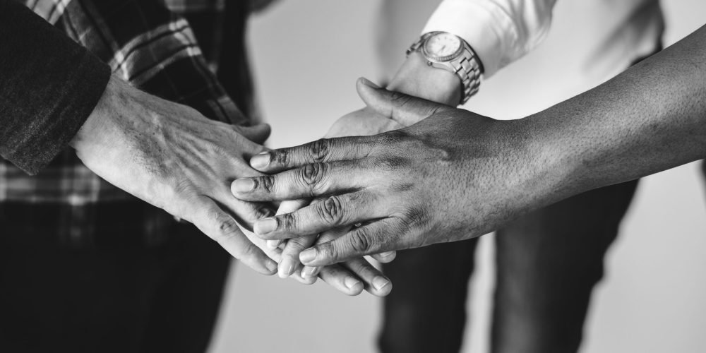 Diverse people joining hands together teamwork and community concept