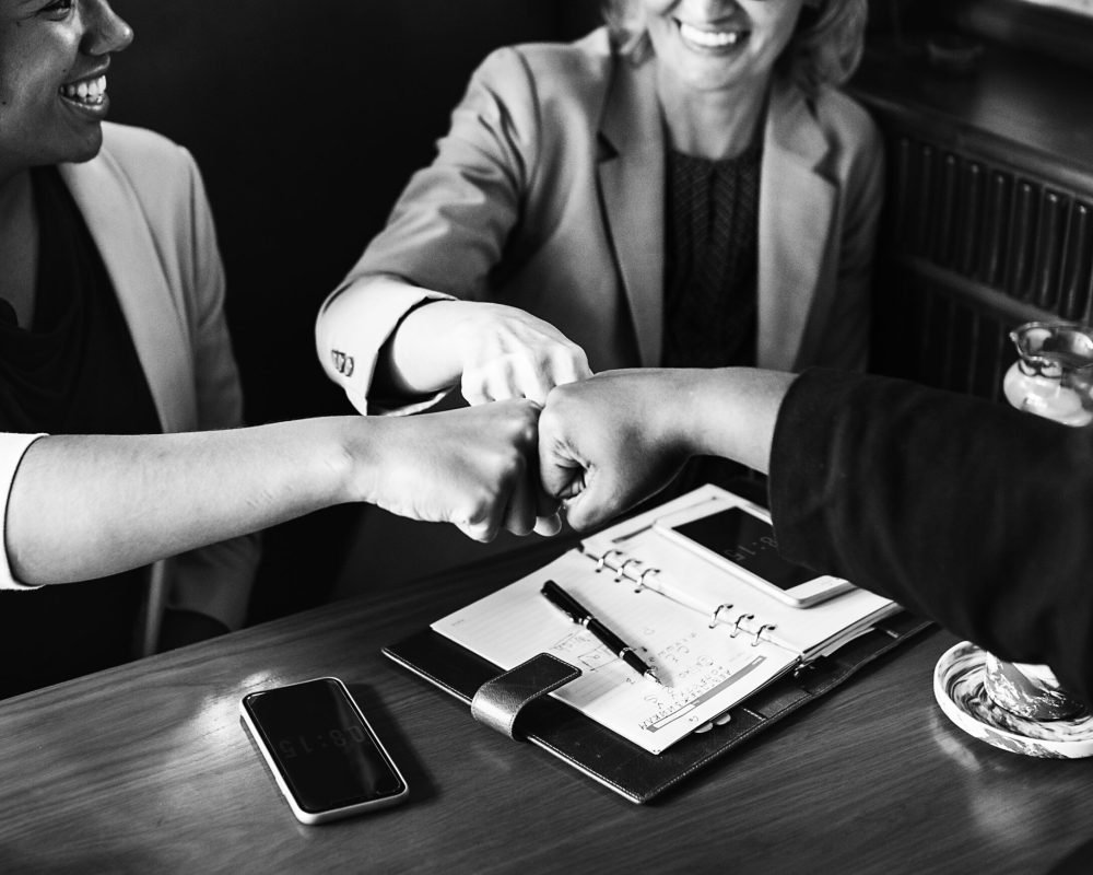 Businesswomen in a fist bump